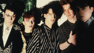 The five members of Fricción pose together in a band photo.
