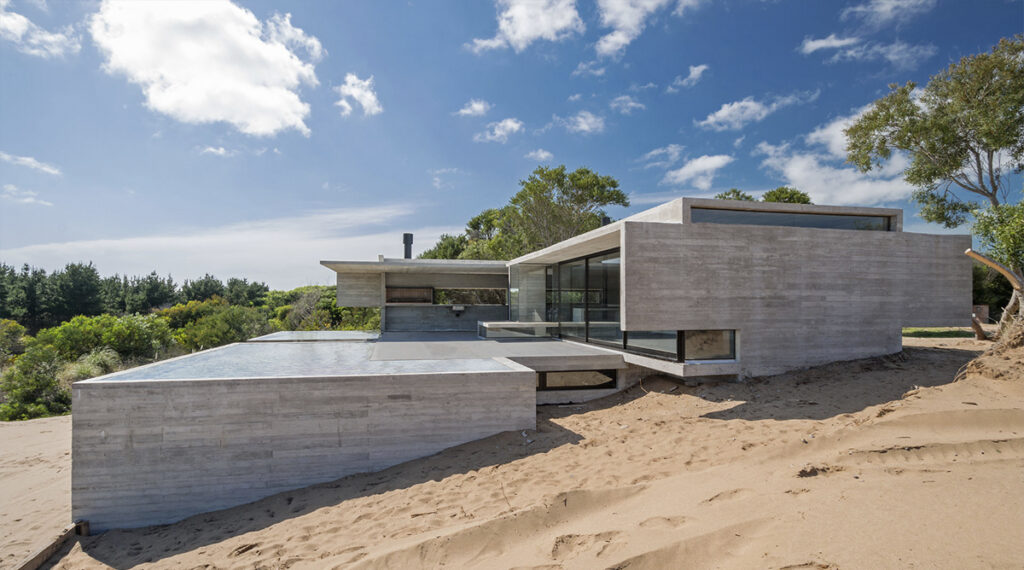 Vivienda de hormigón de Luciano Kruk construida entre las dunas de la costa argentina.