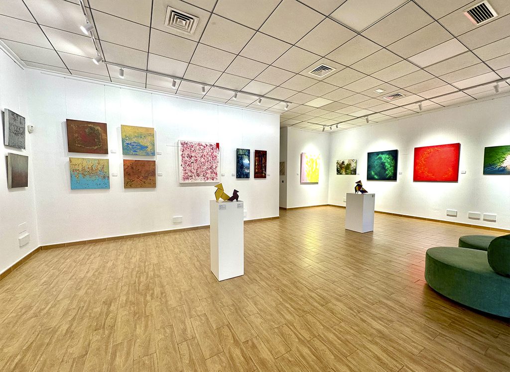 Abstract paintings by Mariam Cremades, featuring color, texture, and relief, on display at her gallery in Alicante.