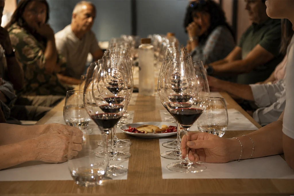 A group of visitors participates in a red wine tasting at Bodegas LA HORRA in Burgos.