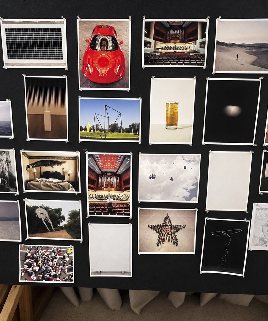 A black panel featuring photographs of cars, landscapes, interiors, objects, and geometric shapes.